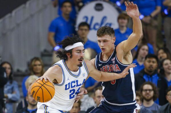 UCLA guard Jaime Jaquez Jr., left, drives against Arizona guard Pelle Larsson during the first half of an NCAA college basketball game Saturday, March 4, 2023, in Los Angeles. (AP Photo/Ringo H.W. Chiu)