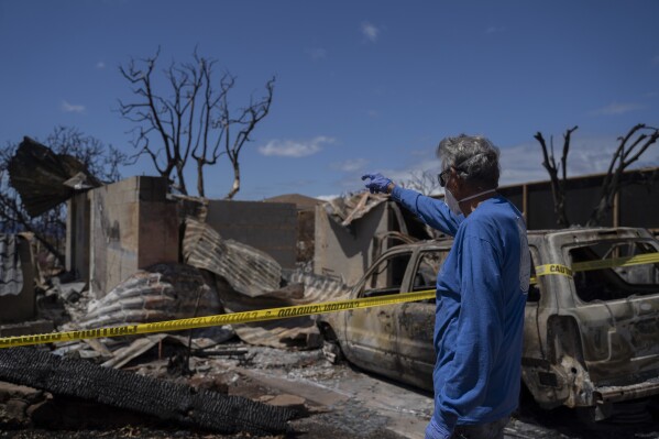 Michael Vierra looks at his house for the first time after the wildfire in August, on Tuesday, Sept. 26, 2023, in Lahaina, Hawaii. (AP Photo/Mengshin Lin)