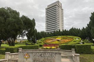 FILE - Malaysia's lower house parliament building is seen in Kuala Lumpur, Malaysia, July 13, 2020. Malaysia's Parliament on Monday, April 3, 2023 approved a bill that would scrap mandatory death penalties and limit capital punishment to serious crimes as part of wide-ranging reforms, bringing possible reprieves to more than 1,300 prisoners on death row. (AP Photo/Vincent Thian, File)