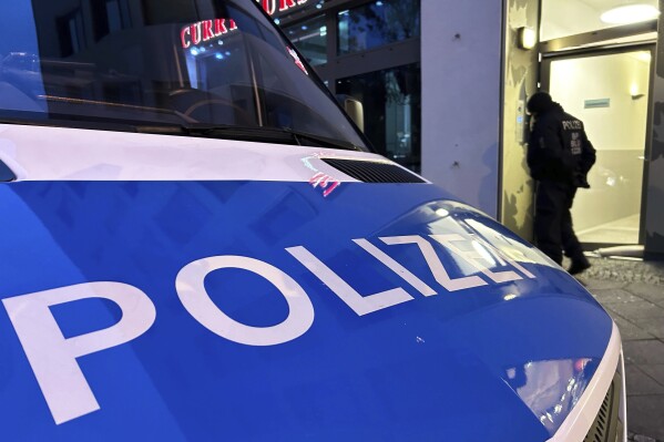 A police vehicle stands on the street during a raid in Berlin-Adlershof in Berlin, Thursday, Nov. 23, 2023. Hundreds of police officers searched the properties of Hamas members and followers in Germany on Thursday morning with the majority of the raids taking place in Berlin.(Sven Kaeuler/dpa via AP)