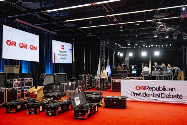 Workers prepare for the Republican presidential debate at Drake University in Des Moines, Iowa, Tuesday, Jan. 9, 2024. (AP Photo/Andrew Harnik)