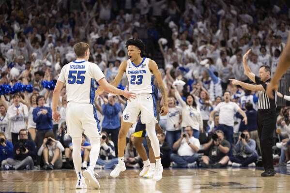 Creighton's Trey Alexander (23) celebrates with Baylor Scheierman (55) after making a three point shot against Marquette during the first half of an NCAA college basketball game Saturday, March 2, 2024, in Omaha, Neb. (AP Photo/Rebecca S. Gratz)