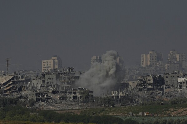 Smoke rises from the Gaza Strip during the ongoing bombardment by the Israeli military on Tuesday, Oct. 31, 2023. Over the past five days, Israeli ground troops have pushed deeper and deeper into Gaza in their war against Hamas, launched in response to a bloody Oct. 7 cross-border raid by the Islamic militant group. Yet even as the operation expands each day, the army refuses to call it an invasion. Its vague choice of words appears to be a deliberate strategy aimed at keeping its enemy off balance and preserving its options as a lengthy war unfolds. (AP Photo/Ariel Schalit)