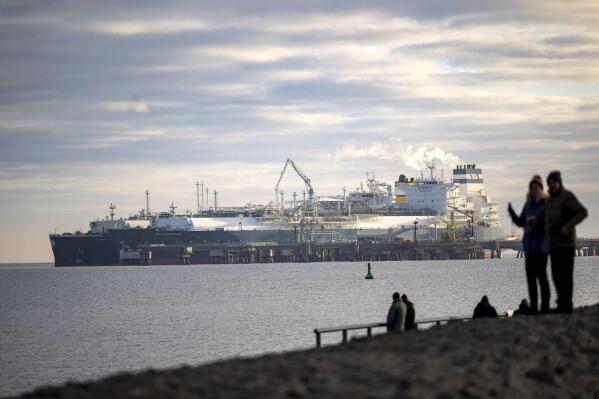 The tanker "Maria Energy", left, loaded with liquefied natural gas, is moored at the floating terminal, the special ship "Hoegh Esperanza", in Wilhelmshaven, Germany, Tuesday Jan. 3, 2023. For the first time since the terminal opened in Wilhelmshaven, a tanker has arrived there with a full cargo of liquefied natural gas (LNG). (Sina Schuldt/dpa via AP)