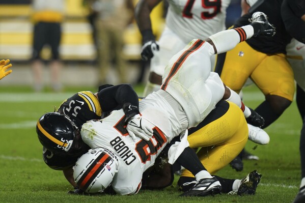 Cleveland Browns running back Nick Chubb is tackled by Pittsburgh Steelers linebacker Cole Holcomb (55) during the first half of an NFL football game Monday, Sept. 18, 2023, in Pittsburgh. (AP Photo/Matt Freed)
