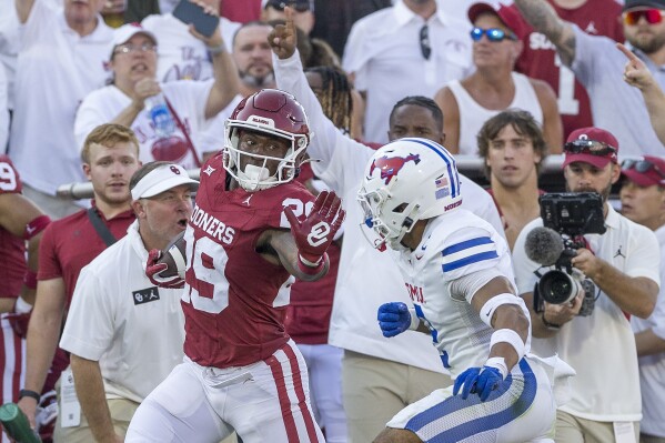 Oklahoma running back Tawee Walker (29) carries past SMU safety Jonathan McGill (2) during the first half of an NCAA college football game Saturday, Sept. 9, 2023, in Norman, Okla. (AP Photo/Alonzo Adams)
