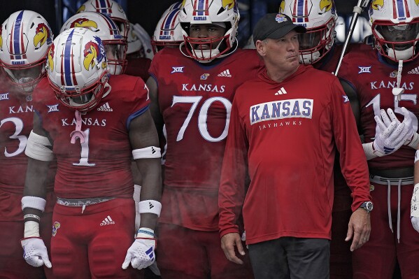Kansas head coach Lance Leipold waits to run onto the field with his team before an NCAA college football game against BYU Saturday, Sept. 23, 2023, in Lawrence, Kan. (AP Photo/Charlie Riedel)
