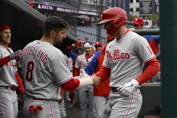 Philadelphia Phillies' Rhys Hoskins, right, celebrates his home run with Nick Castellanos (8) during the first inning in the first baseball game of a doubleheader against the Washington Nationals, Friday, Sept. 30, 2022, in Washington. (AP Photo/Nick Wass)