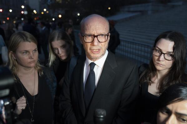 Screenwriter and film director Paul Haggis, center, speaks to a reporter after leaving court after being found guilty in a sexual assault civil lawsuit, Thursday, Nov. 10, 2022, in New York. (AP Photo/John Minchillo)