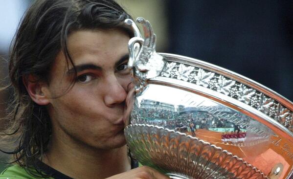 FILE - Spain's Rafael Nadal kisses the cup after defeating Argentina's Mariano Puerta in their final of the French Open tennis tournament, at the Roland Garros stadium, Sunday, June 5, 2005 in Paris. (AP Photo/Lionel Cironneau, File)