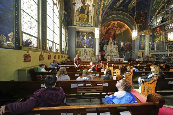 Crafton Elementary School sixth-graders study the murals of Maxo Vanka in St. Nicholas Croatian Catholic Church in Millvale, Pa., on Tuesday, March 18, 2025. (AP Photo/Gene J. Puskar)