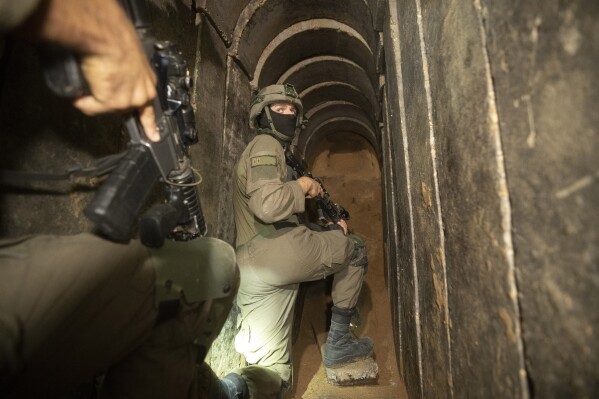 Israeli soldiers escort the media to an underground tunnel found underneath Shifa Hospital in Gaza City, Wednesday, Nov. 22, 2023. Israel says that Hamas militants sought cover on the grounds of the hospital and used the tunnel for military purposes. (AP Photo/Victor R. Caivano)