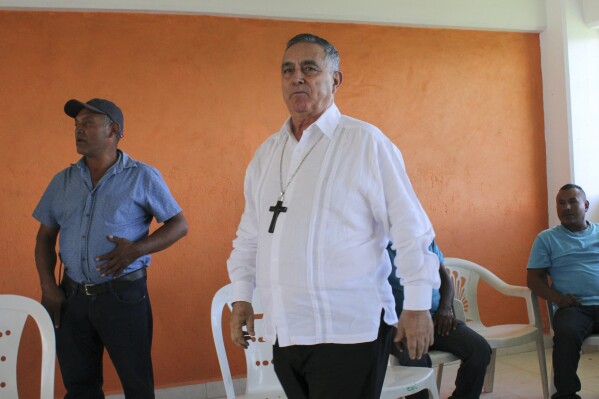 Monsignor Salvador Rangel, bishop of the Chilpancingo-Chilapa diocese, arrives to meet with people displaced by violence in Los Morros, Guerrero, Mexico, July 18, 2018. The retired Roman Catholic bishop who was famous for trying to mediate between drug cartels in Mexico was located and taken to a hospital after apparently being briefly kidnapped, the Mexican Council of Bishops said Monday, April 29, 2024. (AP Photo/Alejandrino Gonzalez)
