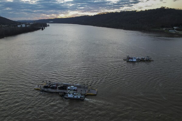 Ferries carry cars across the Ohio River, March 20, 2024, near Cincinnati. (AP Photo/Joshua A. Bickel)