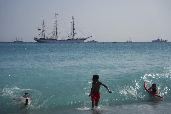 People swim while the ship 'Ocean Wonder' sails during a theme event celebrating World Marine Day ahead of the United Nations Marine Conference to be held in Nice, France on Sunday, June 8th, 2025. (AP Photo/Annika Hammerschlag)