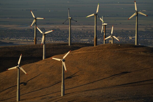 FILE - Wind turbines work in Livermore, Calif., Aug. 10, 2022. Federal energy regulators on Monday, May 13, 2024, approved a long-awaited rule to expand the amount of renewable energy such as wind and solar power that is transmitted to the electric grid, a key part of President Joe Biden’s goal to decarbonize the economy by 2050. (AP Photo/Godofredo A. Vásquez, File)