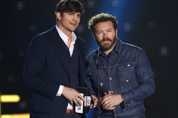 FILE- Ashton Kutcher, left, and Danny Masterson present the award for collaborative video of the year at the CMT Music Awards at Music City Center on June 7, 2017, in Nashville, Tenn. Ashton Kutcher and Mila Kunis are apologizing for character letters the celebrity couple wrote on behalf of Masterson ahead of this week's sentencing of their fellow 