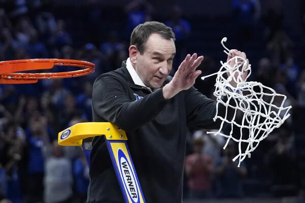 Duke head coach Mike Krzyzewski celebrates while cutting down the net after Duke defeated Arkansas in a college basketball game in the Elite 8 round of the NCAA men's tournament in San Francisco, Saturday, March 26, 2022. (AP Photo/Marcio Jose Sanchez)