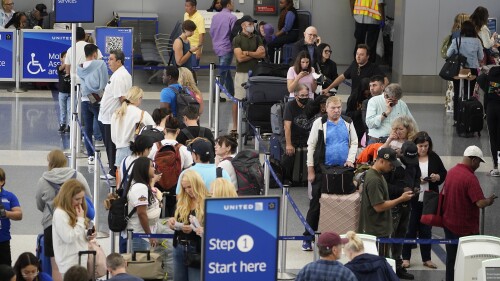 Travelers wait at the departure area check-in at the United Airlines terminal at Los Angeles International airport, Wednesday June 28, 2023, in Los Angeles. Travelers waited out widespread delays at U.S. airports on Tuesday, an ominous sign heading into the long July 4 holiday weekend, which is shaping up as the biggest test yet for airlines that are struggling to keep up with surging numbers of passengers. (AP Photo/Damian Dovarganes)