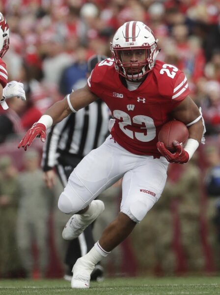 
              FILE - In this Nov. 3, 2018, file photo, Wisconsin's Jonathan Taylor runs during the first half against Rutgers, in Madison, Wis. Taylor was named to the 2018 AP All-America NCAA col...