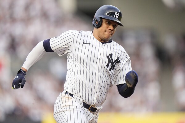 New York Yankees' Juan Soto turns toward home plate to score on a single by Giancarlo Stanton during the first inning of the team's baseball game against the Minnesota Twins, Wednesday, June 5, 2024, in New York. (AP Photo/Frank Franklin II)