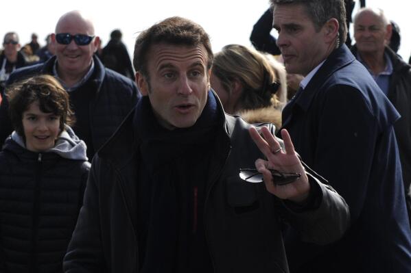 French President and centrist presidential candidate for reelection Emmanuel Macron gestures as he strolls after voting for the first round of the presidential election, Sunday, April 10, 2022 in Le Touquet, northern France. Polls opened across France for the first round of the country's presidential election, where up to 48 million eligible voters will be choosing between 12 candidates. President Emmanuel Macron is seeking a second five-year term, with a strong challenge from the far right. (AP Photo/Louis Witter)