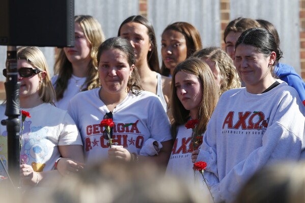 Alpha Chi Omega sorority members mourn the loss of their sorority sister, Laken Riley, during a vigil for the Augusta University College of Nursing student at the Tate Plaza on the University of Georgia campus in Athens, Ga., Monday, Feb. 26, 2024. Riley, a nursing student at Augusta University's Athens campus, was found dead Thursday, Feb. 22, after a roommate reported she didn't return from a morning run in a wooded area of the UGA campus near its intramural fields. Students also gathered to pay tribute to a UGA student who committed suicide last week. (Joshua L. Jones/Athens Banner-Herald via AP)