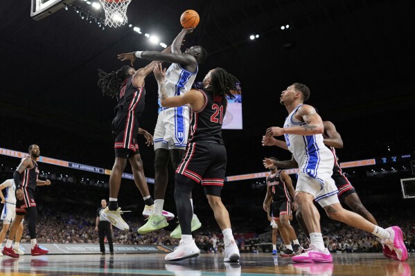 Duke center Khaman Maluach shoots over Houston forward Joseph Tugler during the first half in the national semifinals at the Final Four of the NCAA college basketball tournament, Saturday, April 5, 2025, in San Antonio. (AP Photo/Brynn Anderson)