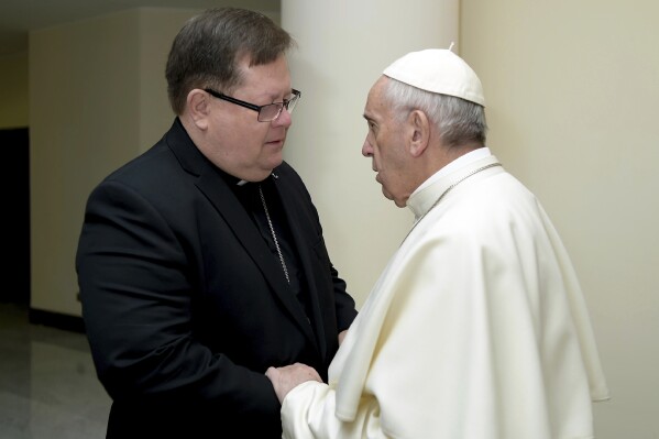FILE - Pope Francis talks to archbishop of Quebec, Cardinal Gerald LaCroix, as they meet at the Santa Marta residence, at the Vatican, Jan. 30, 2017. A retired Canadian judge said Tuesday, May 21, 2024, that he couldn’t find any reliable evidence of sexual misconduct by the archbishop of Quebec, after the purported victim refused to be interviewed and the cardinal strongly denied the claim. (L'Osservatore Romano/Pool Photo via AP, File)