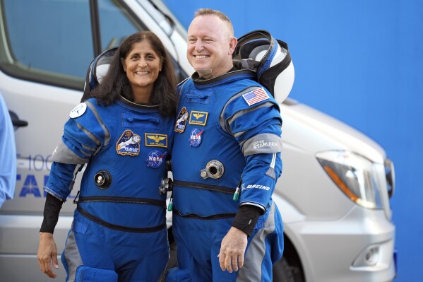 NASA astronauts Suni Williams, left, and Butch Wilmore pose for a photo after leaving the operations and checkout building for a trip to launch pad at Space Launch Complex 41 Wednesday, June 5, 2024, in Cape Canaveral, Fla. The two astronauts are scheduled to liftoff later today on the Boeing Starliner capsule for a trip to the international space station. (AP Photo/Chris O'Meara)