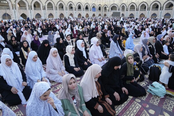 FILE - Muslims perform Eid prayers on the first day of Eid al-Adha holiday at the Sunni shrine of Abdul-Qadir al-Gailani in Baghdad, Iraq, Wednesday, June 28, 2023. In the Middle East and North Africa, where religion is often ingrained in daily life's very fabric, rejecting faith can come with social or other repercussions, so many of the "nones," a group that includes agnostics, atheists and "nothing in particular" conceal that part of themselves, as blasphemy laws and policies are widespread in the region. (AP Photo/Hadi Mizban, File)