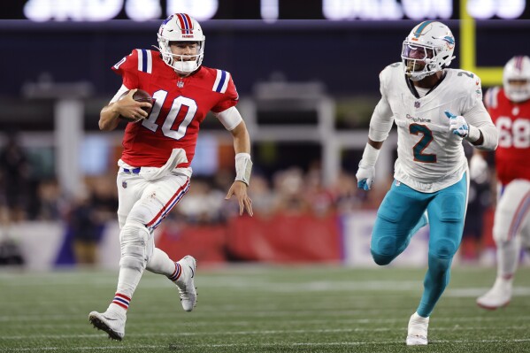 New England Patriots quarterback Mac Jones (10) tries to out run Miami Dolphins linebacker Bradley Chubb (2) during the second half of an NFL football game, Sunday, Sept. 17, 2023, in Foxborough, Mass. (AP Photo/Michael Dwyer)