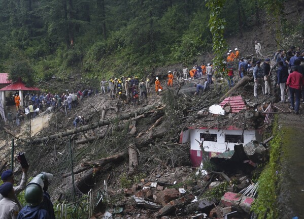 FILE - Rescuers remove mud and debris as they search for people feared trapped after a landslide near a temple on the outskirts of Shimla, Himachal Pradesh state, Aug.14, 2023. Voters in India, from the rain-drenched Himalayas in the north to the sweltering, dry south, are looking for politicians who promise relief, stability and resilience to the wide-ranging and damaging effects of a warming climate. (AP Photo/ Pradeep Kumar, File)