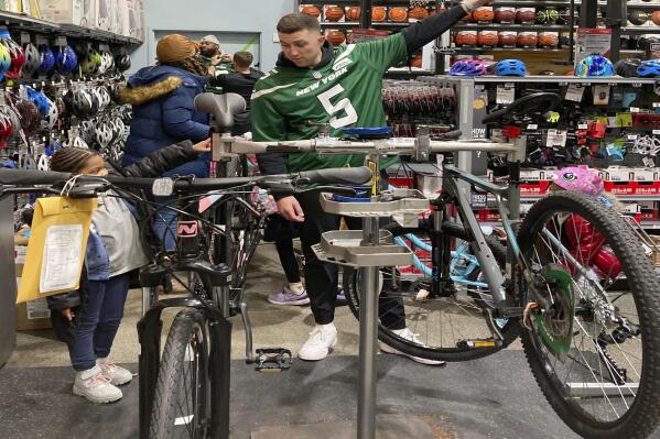 New York Jets quarterback Mike White helps a student from Brooklyn Community Services' Jets Academy shop for a bicycle at Dick's Sporting Goods in East Hanover, N.J., on Tuesday, Dec. 13, 2022. The Jets hosted a holiday shopping spree for 25 students from Brooklyn Community Services' Jets Academy. (AP Photo/Dennis Waszak Jr.)