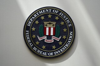 FILE - An FBI seal is seen on a wall on Aug. 10, 2022, in Omaha, Neb. A former American diplomat who served as U.S. ambassador to Bolivia has been arrested in a long-running FBI counterintelligence investigation, accused of secretly serving as an agent of Cuba’s government, The Associated Press has learned. (AP Photo/Charlie Neibergall, File)