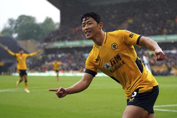 Wolverhampton Wanderers' Hwang Hee-chan celebrates after scoring his side's opening goal during the English Premier League soccer match between Wolverhampton Wanderers and Newcastle United at Molineux stadium in Wolverhampton, England, Saturday, Oct. 2, 2021. (Nick Potts/PA via AP)