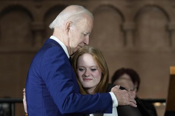 President Joe Biden hugs Sandy Hook survivor Jackie Hegarty before he speaks during an event in Washington, Wednesday, Dec. 7, 2022, with survivors and families impacted by gun violence for the 10th Annual National Vigil for All Victims of Gun Violence. (AP Photo/Susan Walsh)