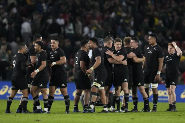 New Zealand's players celebrate at the end of the Rugby Championship test between South Africa and New Zealand at Ellis Park Stadium in Johannesburg, South Africa, Saturday, Aug. 13, 2022. (AP Photo/Themba Hadebe)