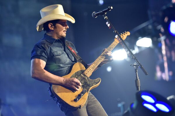 FILE - This Feb. 24, 2018 file photo shows Brad Paisley performing in Rosemont, Ill.  Paisley will perform in Live Nation's “Live from the Drive-In,” concert series taking place July 10-12.  (Photo by Rob Grabowski/Invision/AP, File)