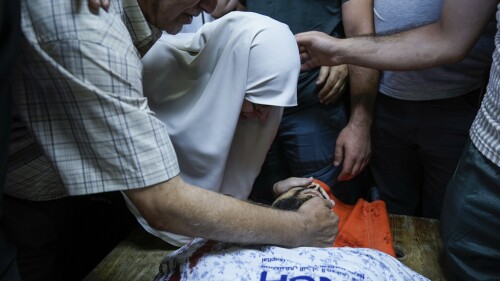 Palestinians mourn around the body of Mohammed Nada, 23, at the hospital's morgue ahead of his funeral in the West Bank city of Nablus, Wednesday, July 26, 2023. Israeli troops entered the Al-Ein refugee camp near the West Bank city of Nablus on Wednesday and arrested a man suspected of shooting at an Israeli bus earlier this week. During the incident, Nada was shot in the chest and later died of his wounds, the Palestinian health ministry said. (AP Photo/Majdi Mohammed)