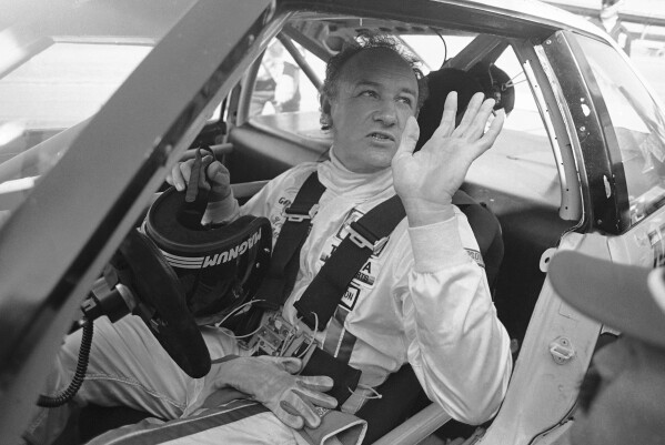 Actor Gene Hackman waves as he starts out for a practice run in his Toyota Celica, Feb. 5, 1983 at the Daytona International Speedway in preparation for the Daytona 24 Hour Endurac Race. This race marks the start of Hickman?s career as a professional driver. (AP Photo/Bob Self, File)