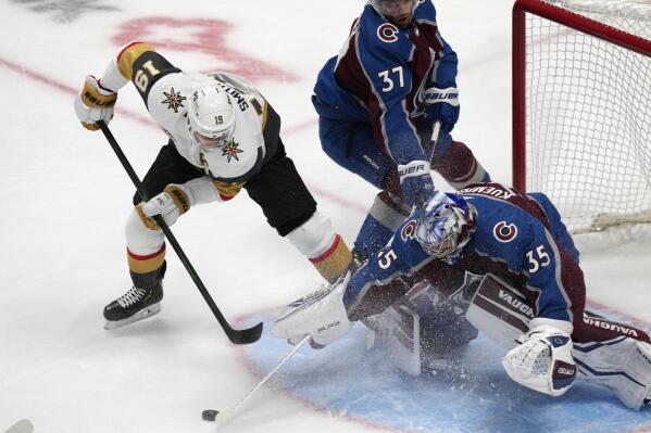 Colorado Avalanche goaltender Darcy Kuemper, right, makes a stick save of a shot by Vegas Golden Knights right wing Reilly Smith, left, as Colorado left wing J.T. Compher helps to defend in the first period of an NHL hockey game Tuesday, Oct. 26, 2021, in Denver. (AP Photo/David Zalubowski)