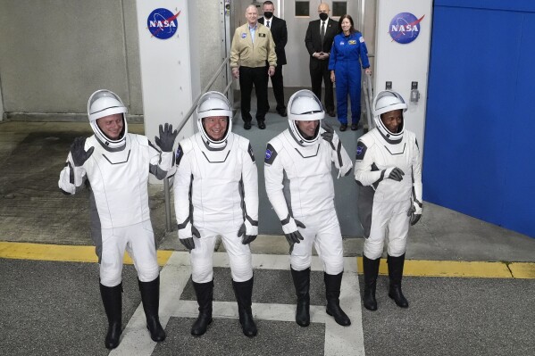 Astronauts, from left, Russian cosmonaut Alexander Grebenkin, pilot Michael Barratt, commander Matthew Dominick, and mission specialist Jeanette Epps wave to the media as they leave the Operations and Checkout building for a trip to Launch Pad 39-A, Sunday, March 3, 2024, at the Kennedy Space Center in Cape Canaveral, Fla. Four astronauts are scheduled to liftoff on a trip to the International Space Station. (AP Photo/John Raoux)