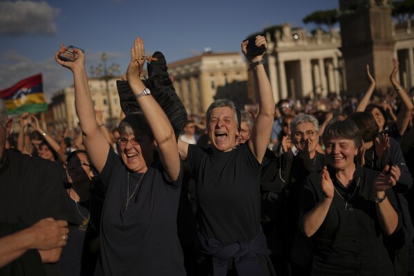 Faithful react after the announcement of the newly elected Pope Leo XIV at the Vatican, May 8, 2025. (AP Photo/Francisco Seco)