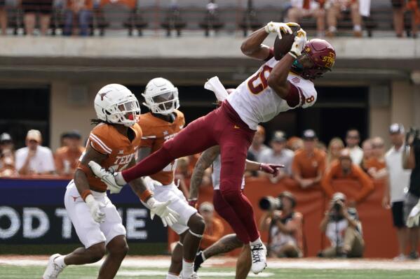 Iowa State wide receiver Xavier Hutchinson (8) makes a catch over Texas defensive back Jaylon Guilbeau, left, during the second half of an NCAA college football game, Saturday, Oct. 15, 2022, in Austin, Texas. (AP Photo/Eric Gay)