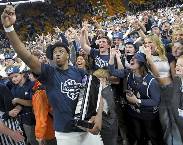 Utah State forward Great Osobor celebrates with fans after the team's win over New Mexico in an NCAA college basketball game Saturday, March 9, 2024, in Logan, Utah. (Eli Lucero/The Herald Journal via AP)