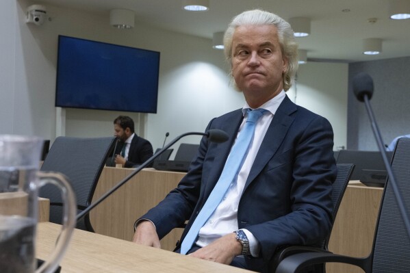 FILE - Politician Geert Wilders listenes, as the court delivers it's verdict against a former Pakistan cricketer accused of incitement to kill, at the high security court building near Schiphol airport, Monday, Sept. 11, 2023. Far right Dutch election winner Geert Wilders on Monday withdrew proposed legislation calling for a ban on mosques and the Quran — in a concession to potential coalition partners a day before talks to form the next government were set to resume. (AP Photo/Peter Dejong), File)