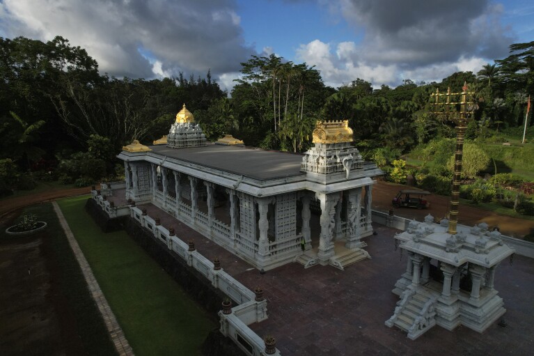 The sun shines down on the golden spires of the Iraivan Temple at Kauai's Hindu Monastery, on July 10, 2023, in Kapaa, Hawaii. The temple is made entirely of hand-carved granite, which the monks have been constructing for the last 33 years. It was completed in March and marked with a special opening ceremony the same month. (AP Photo/Jessie Wardarski)