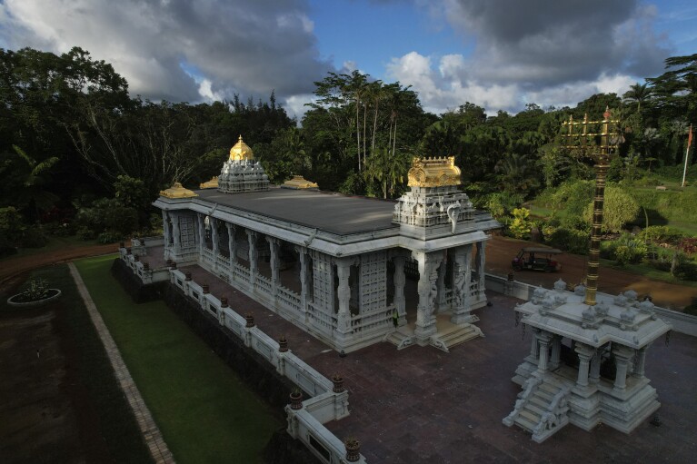 The sun rises on the golden spiers of the Erayvan Temple at Kauai Hindu Monastery, on July 10, 2023, in Kapa'a, Hawaii. The temple is made entirely of hand-carved granite, which the monks have been building for 33 years. It was completed in March and celebrated with a special opening ceremony the same month. (AP Photo/Jesse Wardarski)