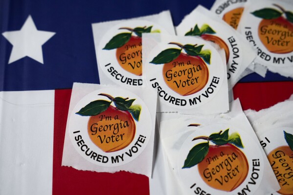 Stickers lay on a table inside a polling place, Tuesday, Nov. 5, 2024, in Atlanta. (AP Photo/Brynn Anderson, File)
